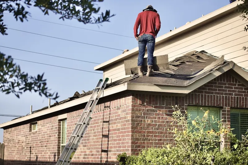 Professional roofer working on a residential roof in Sycamore